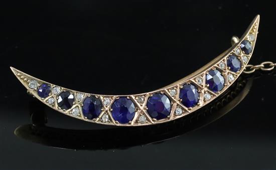 An Edwardian gold, graduated sapphire and rose cut diamond set crescent brooch, 5cm.